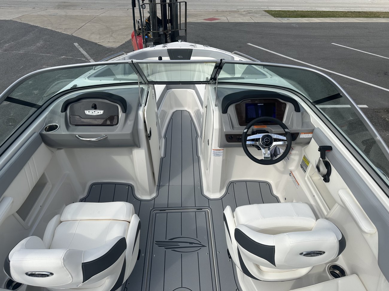 The deckboat is a cross between a bowrider and a pontoon boat.  It features a rather flat deck area with lots of room for people while still offering the speed and agility of a runabout.